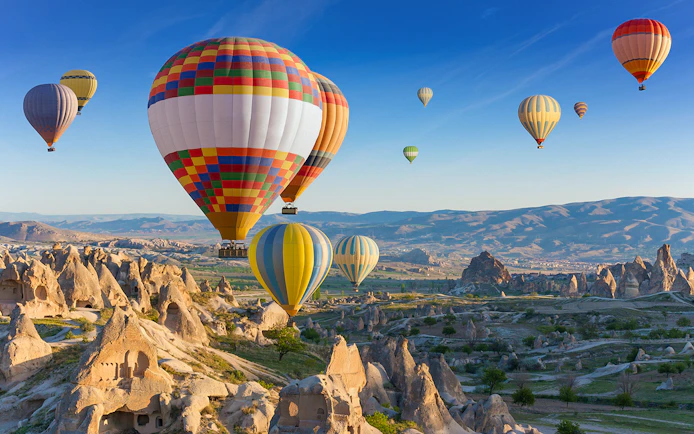 Hot air balloons floating over Cappadocia's unique rock formations.