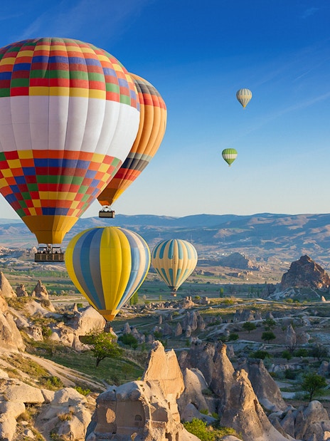 Hot air balloons floating over Cappadocia's unique rock formations.
