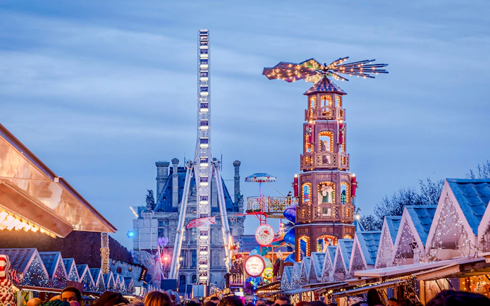 Christmas Market at Tuileries Garden in Paris with festive stalls and Ferris wheel.