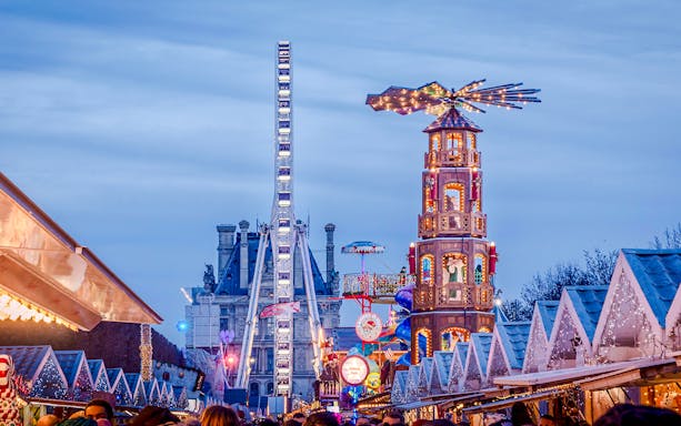 Christmas Market at Tuileries Garden in Paris with festive stalls and Ferris wheel.