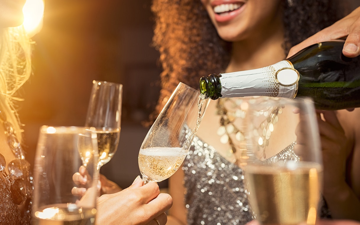 Champagne being poured into glasses at Moulin Rouge Valentine's Day dinner.