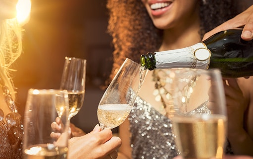 Champagne being poured into glasses at Moulin Rouge Valentine's Day dinner.