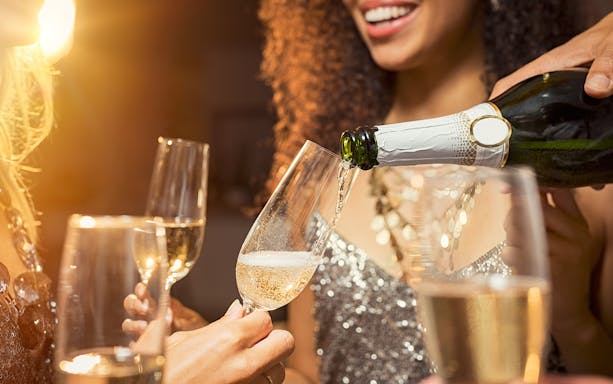 Champagne being poured into glasses at Moulin Rouge Valentine's Day dinner.
