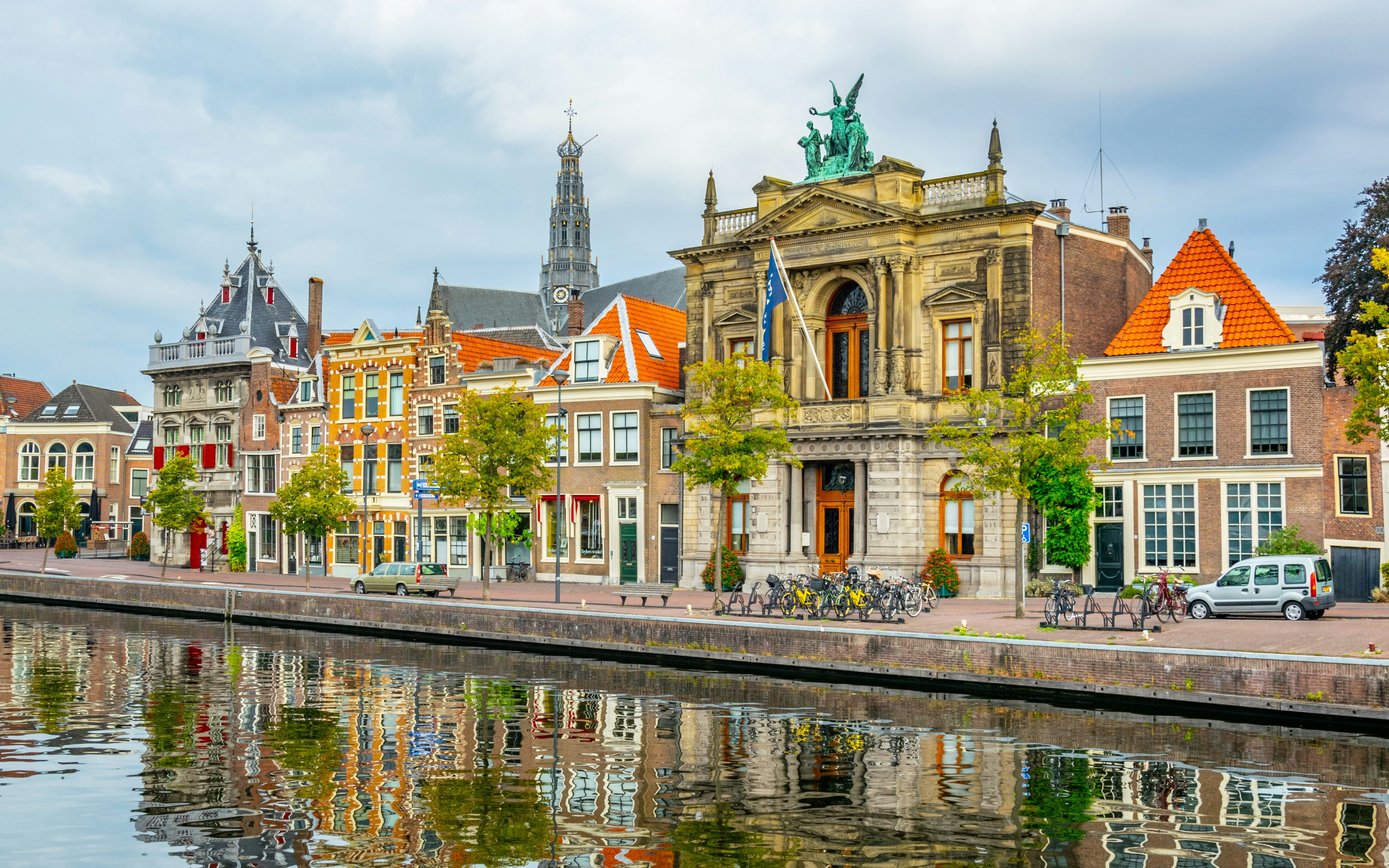 Teylers Museum along a canal in Haarlem, Netherlands, with historic buildings nearby.