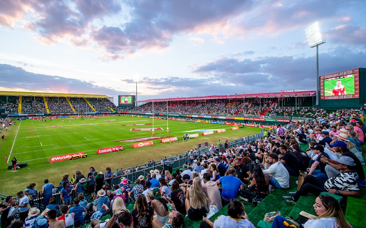 Crowd watching rugby match at Emirates Dubai 7s stadium.