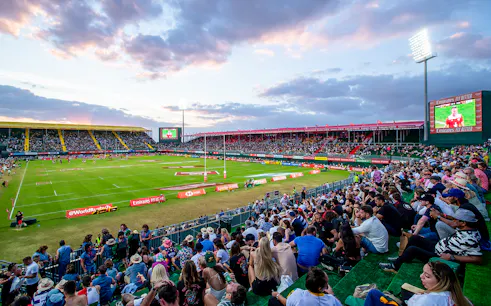 Crowd watching rugby match at Emirates Dubai 7s stadium.