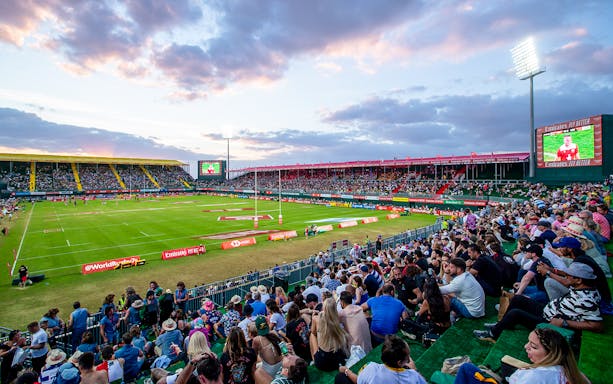 Crowd watching rugby match at Emirates Dubai 7s stadium.