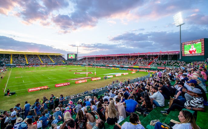 Crowd watching rugby match at Emirates Dubai 7s stadium.