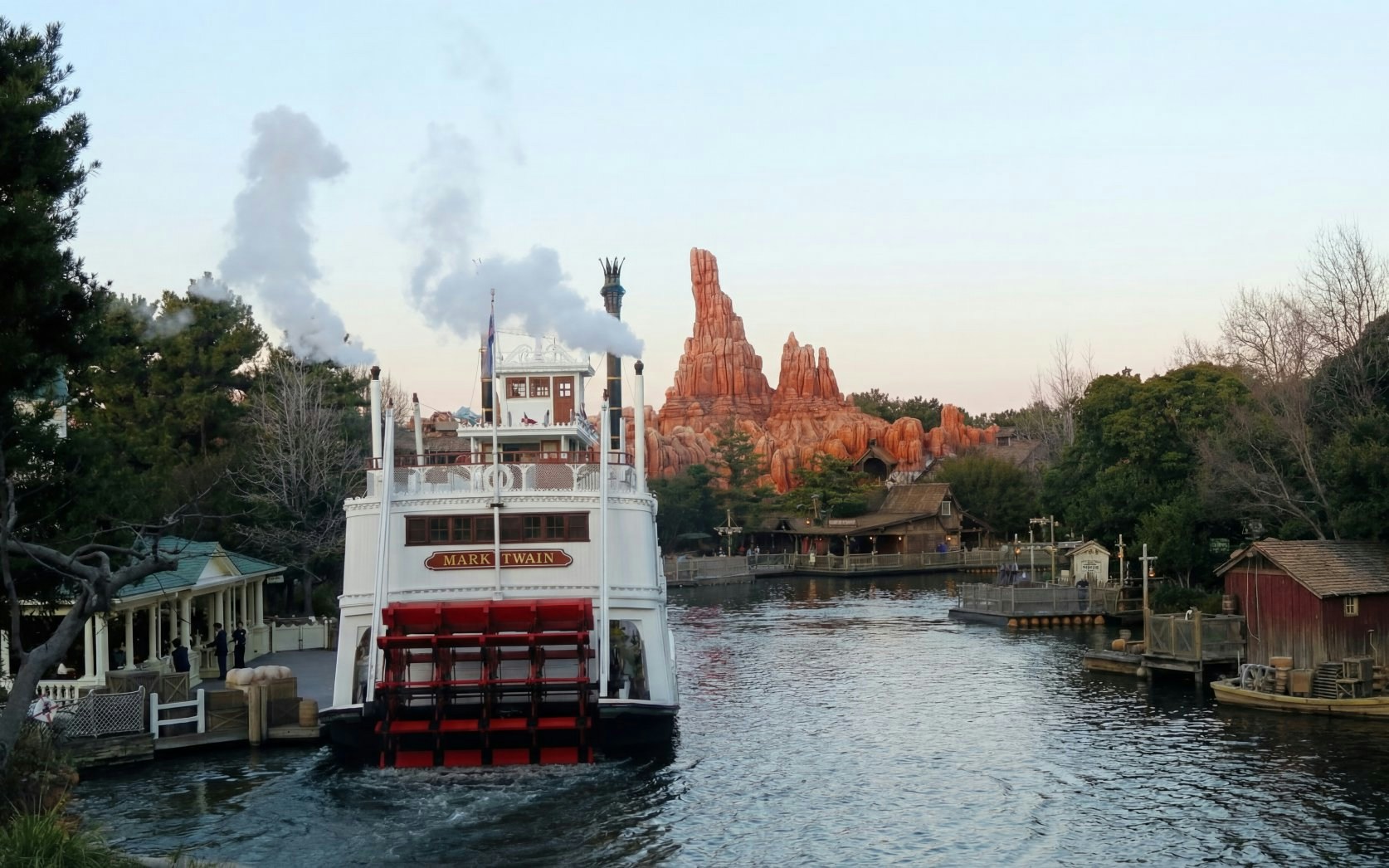Mark Twain Riverboat on river with Big Thunder Mountain in background, Disney Resort, Tokyo, Japan.