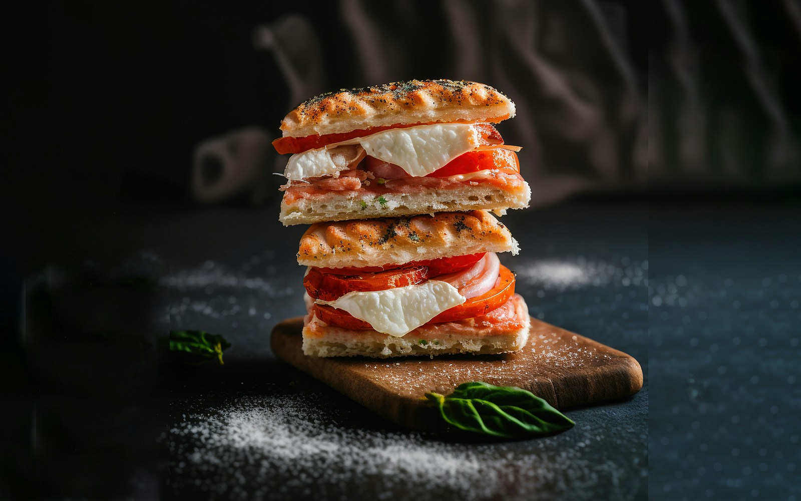 Flatbread sandwich with fresh vegetables and herbs on a wooden board.