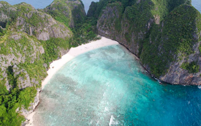 Aerial view of Maya Bay's turquoise waters and white sand beach, Krabi.