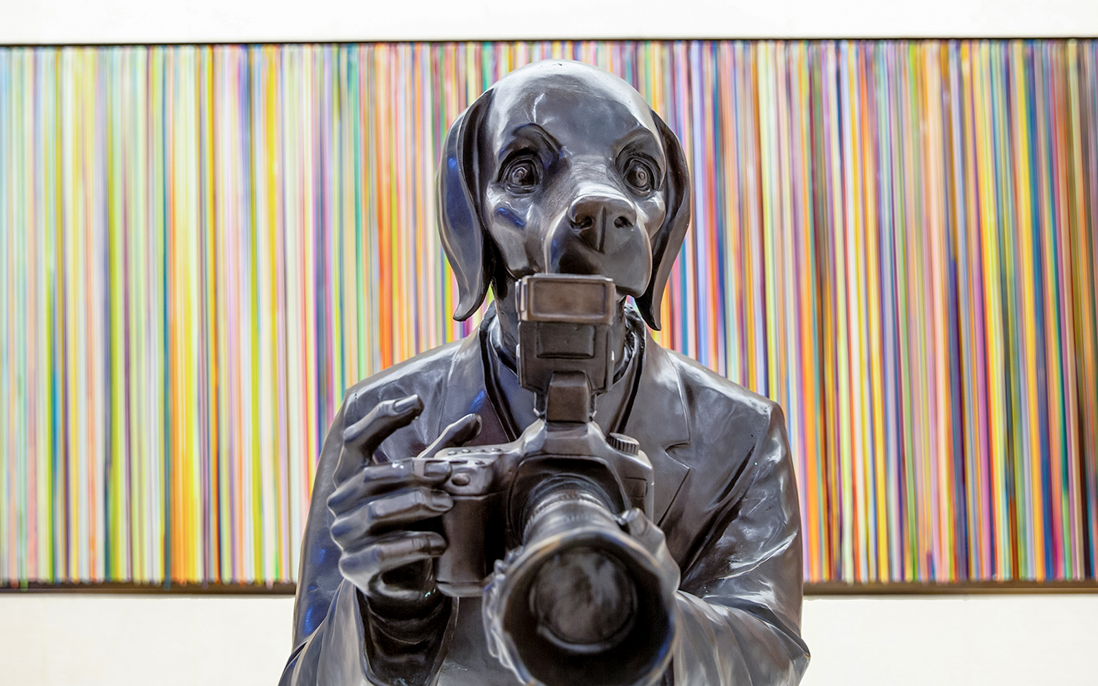 Statue of a dog-headed figure with a camera at Rockefeller Center.