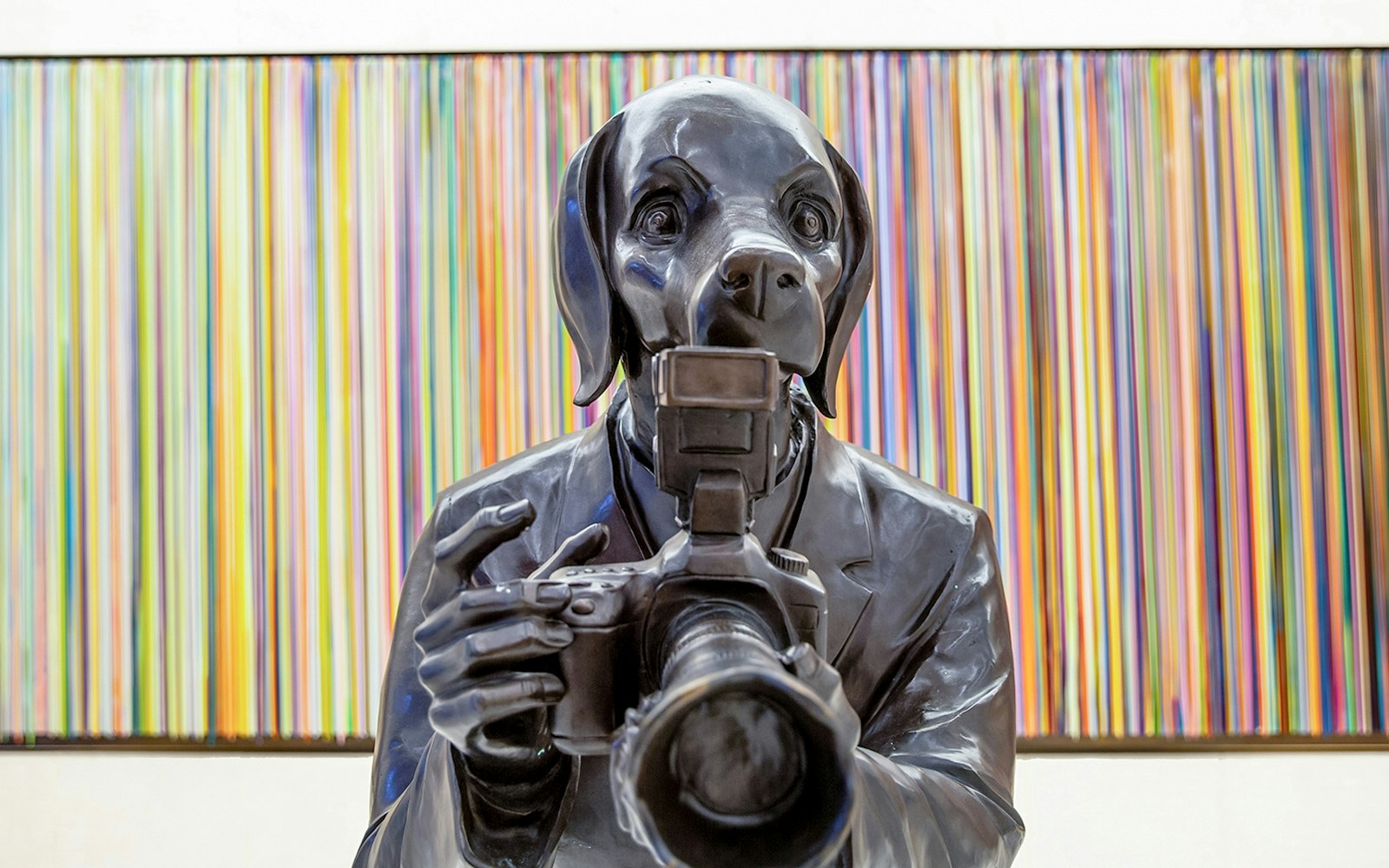 Sculpture of a dog-headed figure with a camera at Rockefeller Center.