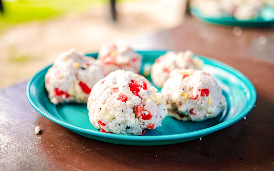Rice balls with vegetables on a blue plate at Bukit Elephant Park.