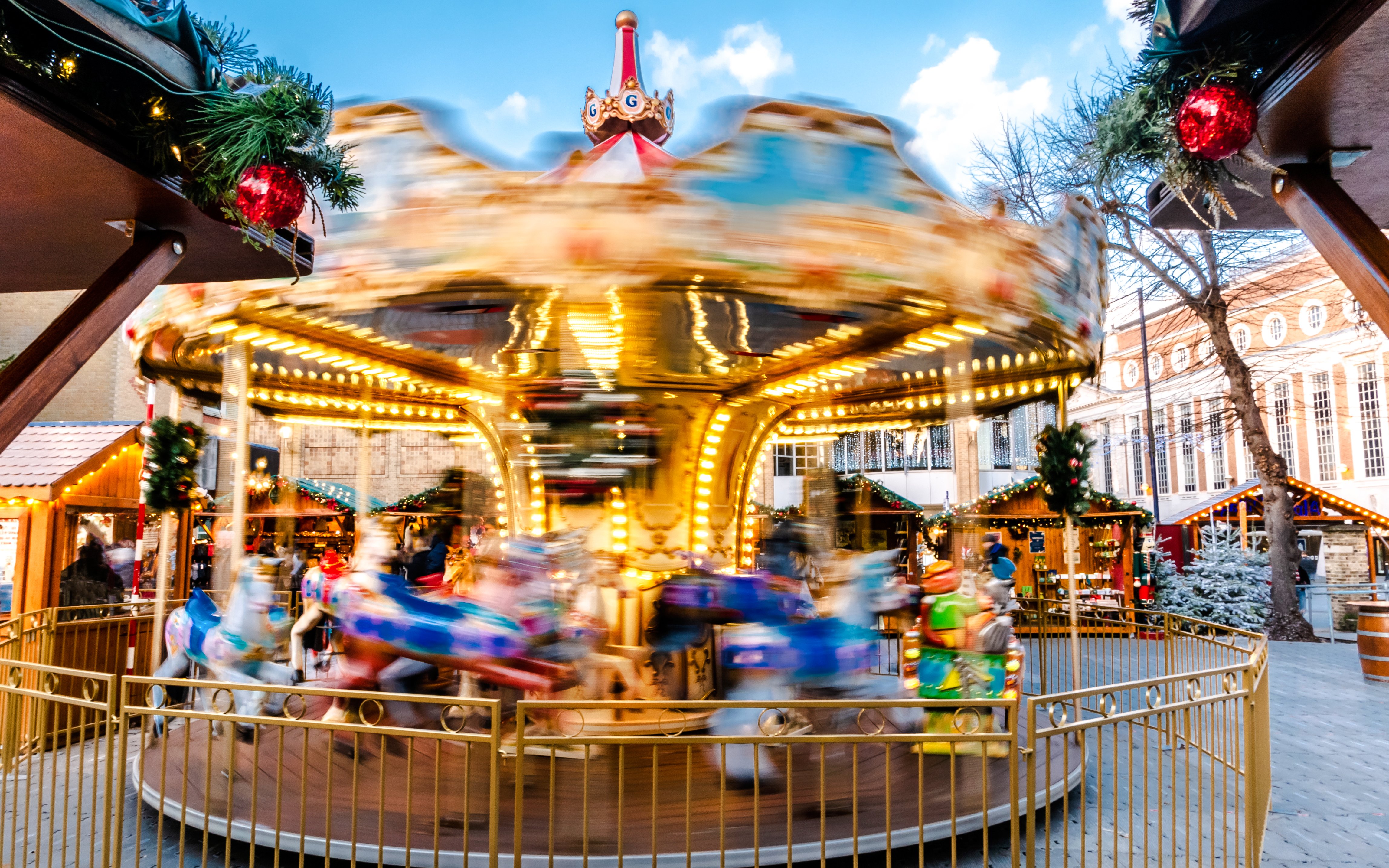 Carousel spinning at Christmas Market in Kingston Upon Thames during winter holiday.