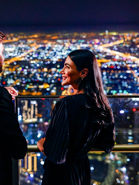 Couple enjoying night view from Burj Khalifa Level 152 Lounge, Dubai.