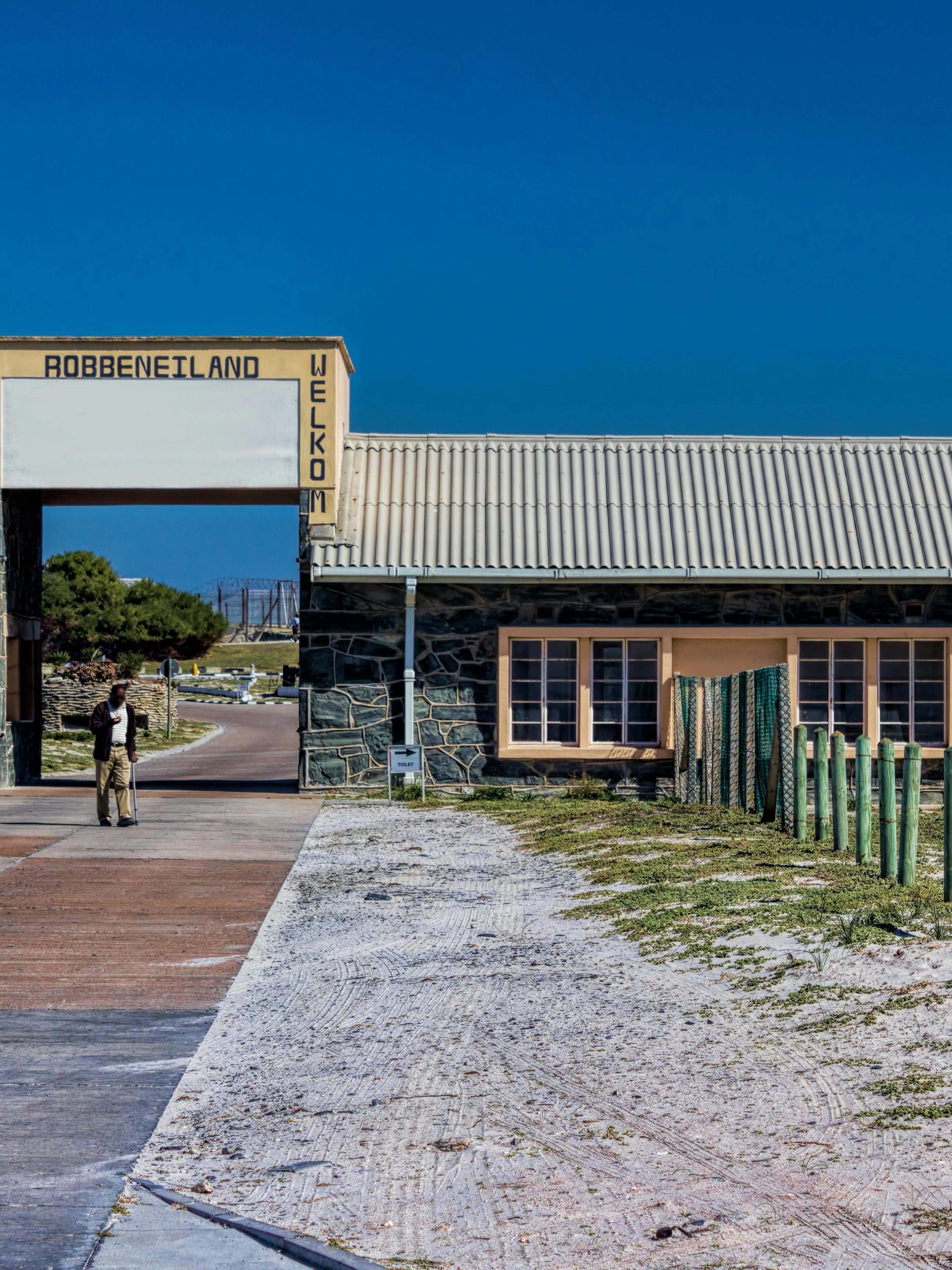 Robben Island entrance with welcome sign and pathway, South Africa.