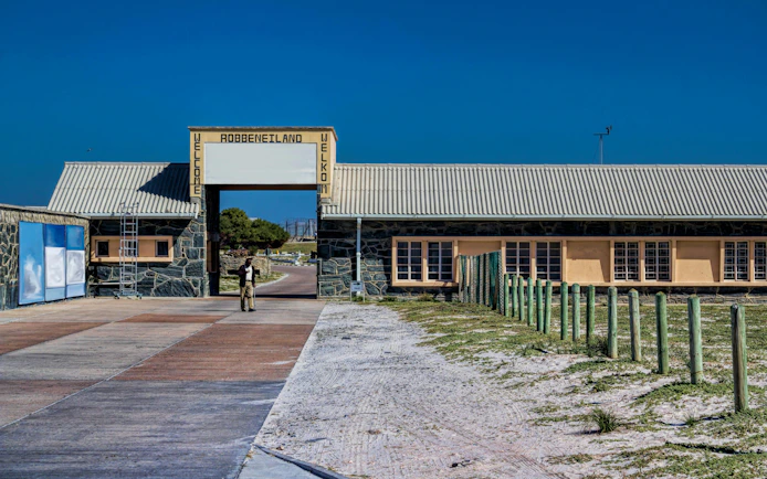 Robben Island entrance with welcome sign and pathway, South Africa.