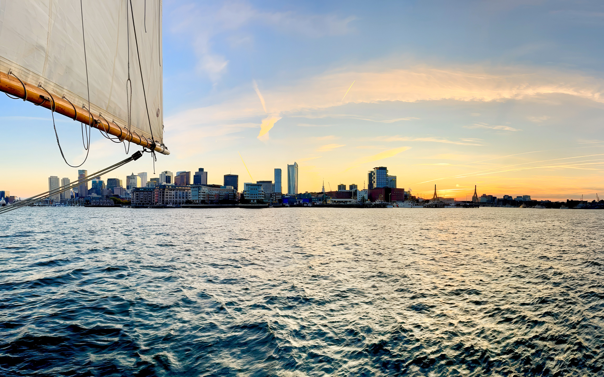Sailboat view of Boston skyline at sunset from Liberty Star Boston.