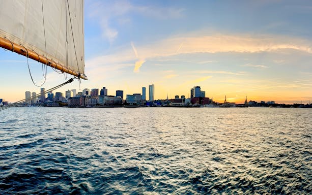 Sailboat view of Boston skyline at sunset from Liberty Star Boston.
