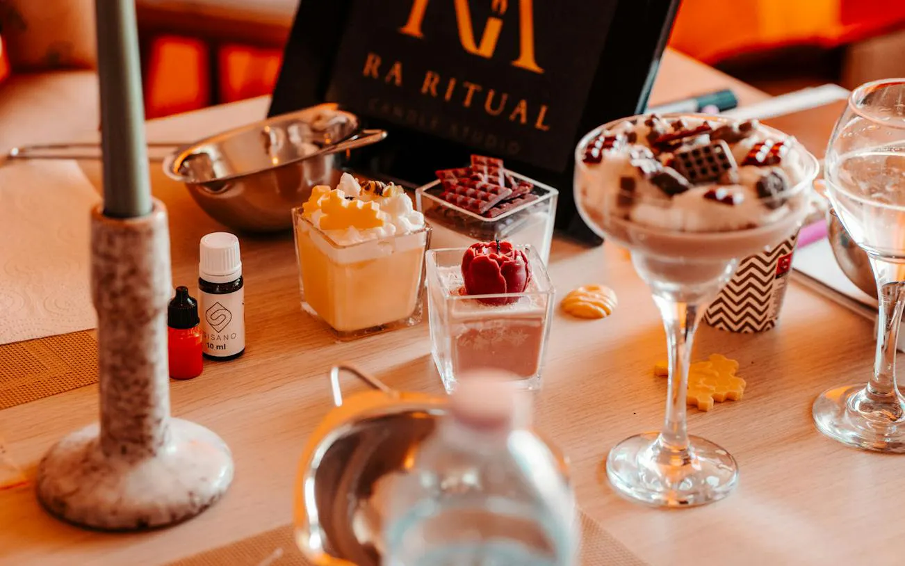 Candle-making supplies and fragrances on a table at a Krakow luxury studio workshop.