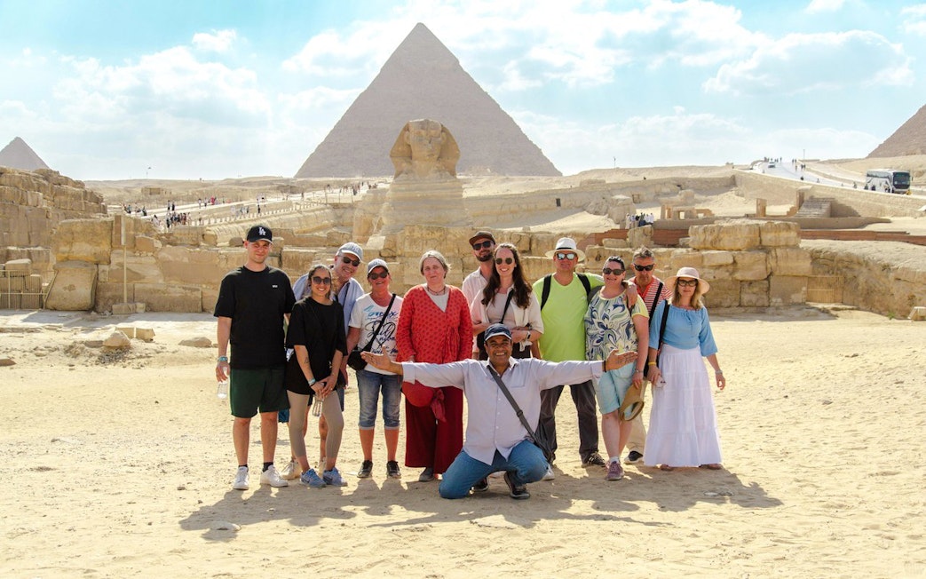 Group posing with the Sphinx and Pyramid in Cairo during a day trip from Hurghada.