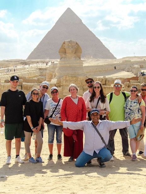 Group posing with the Sphinx and Pyramid in Cairo during a day trip from Hurghada.