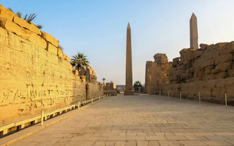 Queen Hatshepsut Obelisk at Karnak Temple Complex, Luxor, Egypt with hieroglyphs on stone walls.