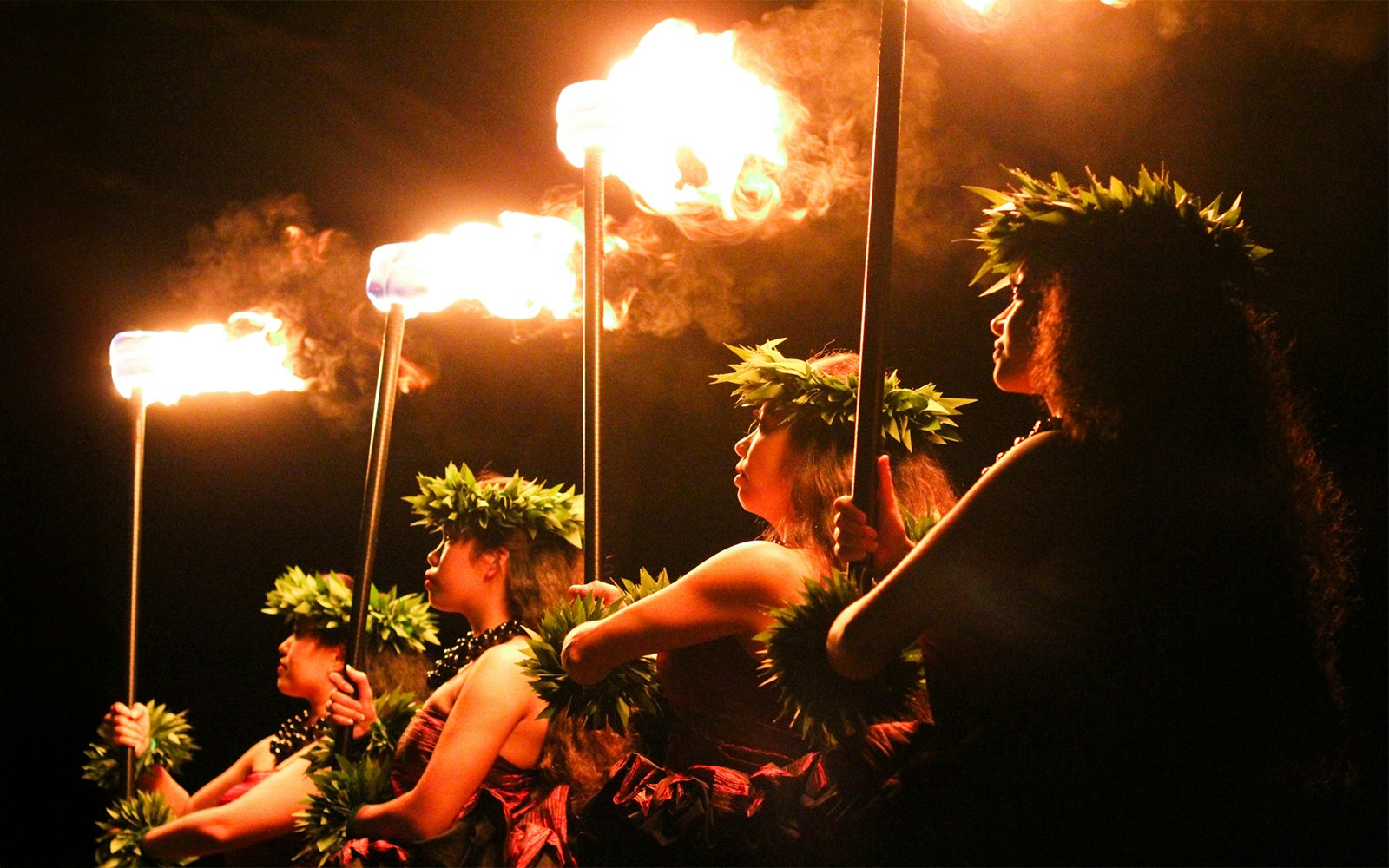 Performers with torches at Moana Luau, Hawaii.