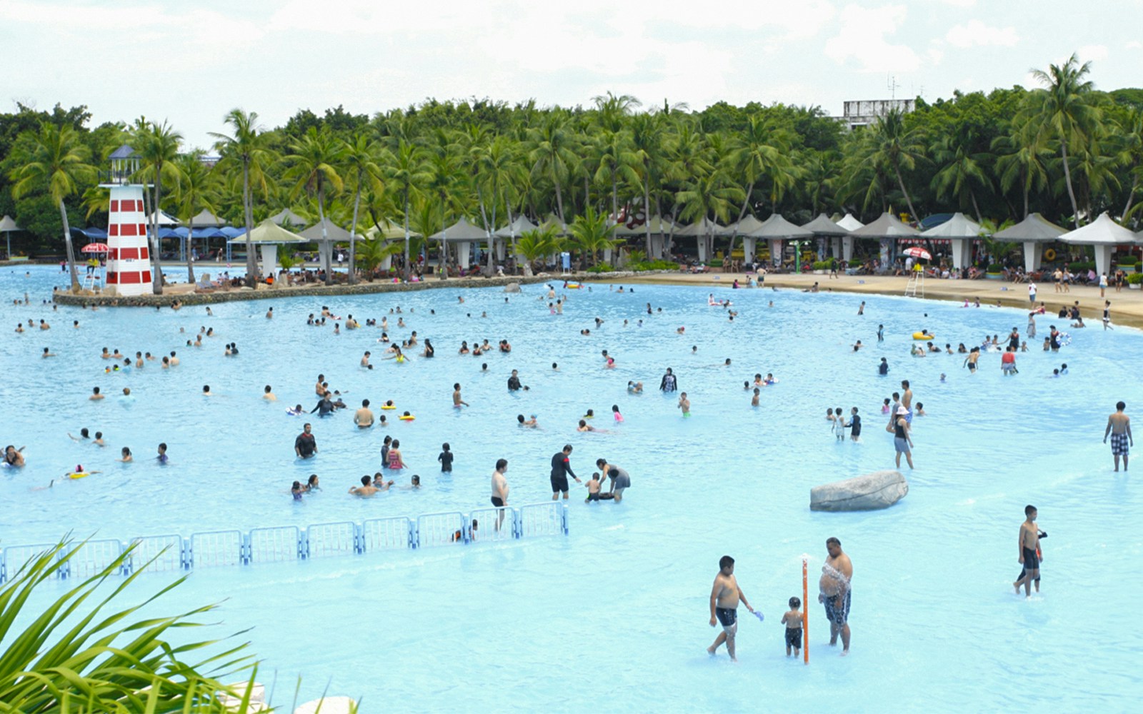 Visitors enjoying the world's largest wave pool at Siam Amazing Park, Bangkok.