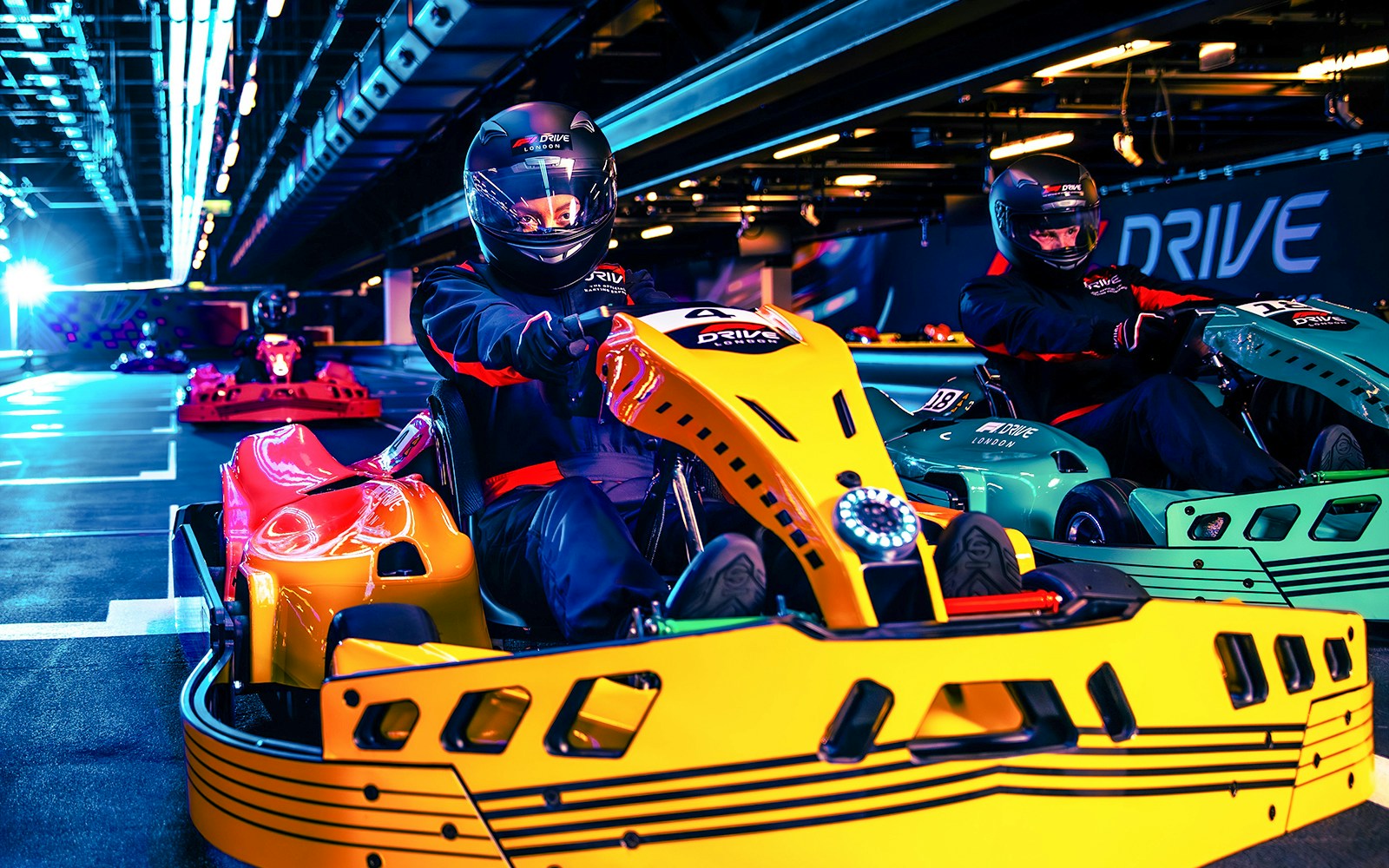Guests driving go-karts at Elite F1 Drive experience in London.