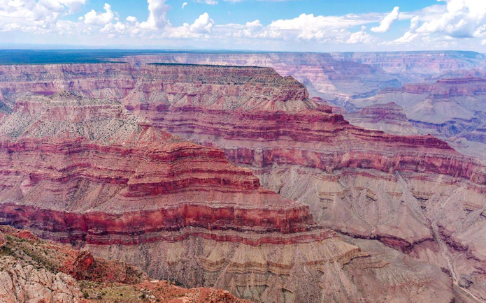 Grand Canyon South Rim aerial view with layered rock formations.