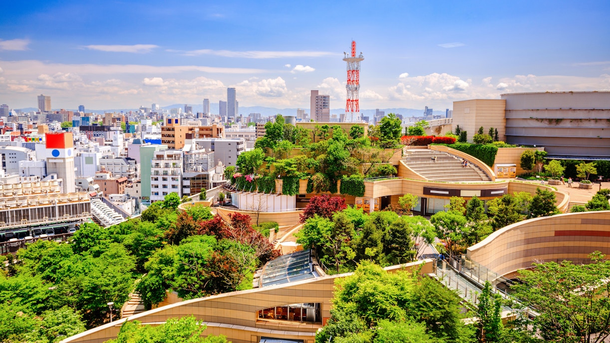 Namba Parks rooftop garden with lush greenery and cityscape in Osaka, Japan.