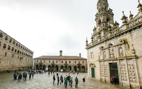Tour group outside Santiago de Compostela Cathedral, Spain.