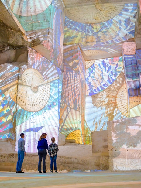Visitors viewing Monet projections at Carrières des Lumières, Les Baux-de-Provence.