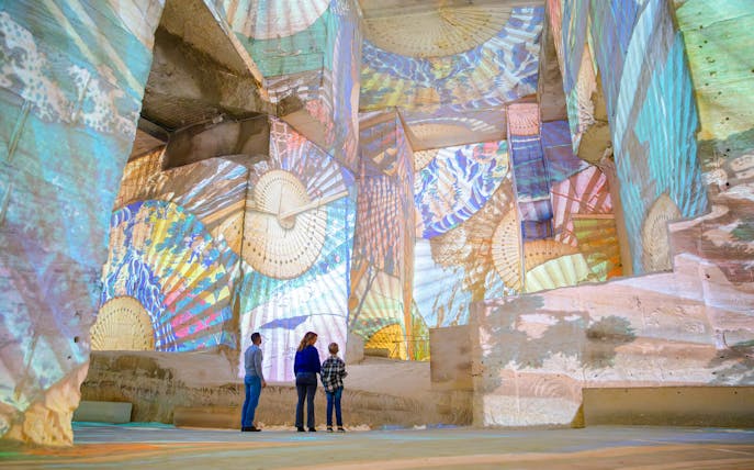 Visitors viewing Monet projections at Carrières des Lumières, Les Baux-de-Provence.