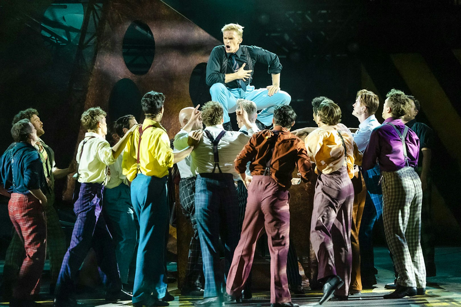 Performers in colorful costumes during "Guys & Dolls" on Sydney Harbour stage.