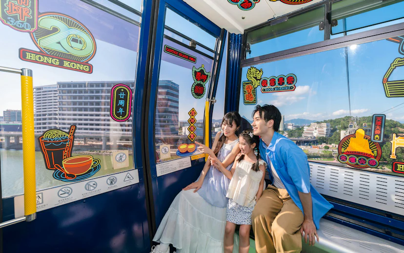 Family enjoying Ngong Ping 360 cable car ride on Lantau Island, Hong Kong.