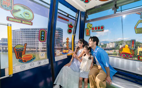 Family enjoying Ngong Ping 360 cable car ride on Lantau Island, Hong Kong.