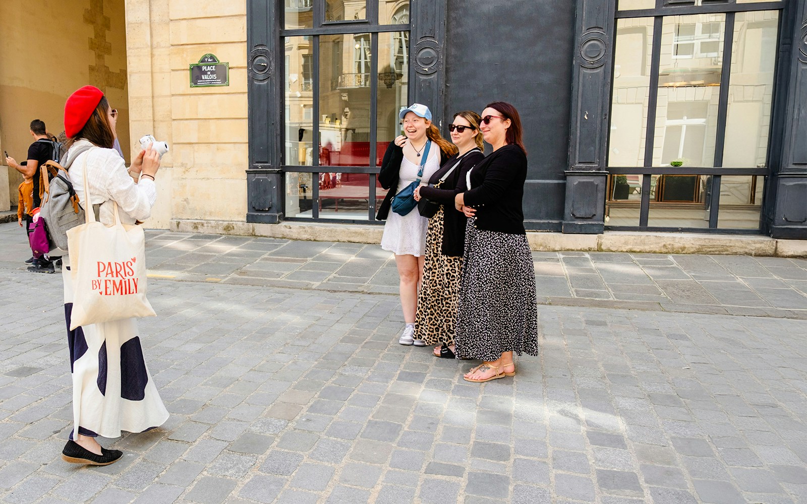 Guide taking Polaroid photos of guests on Emily in Paris Locations Walking Tour.