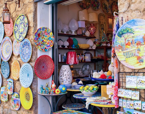 Sorrento souvenir shop with colorful ceramic plates and local crafts, Amalfi Coast.