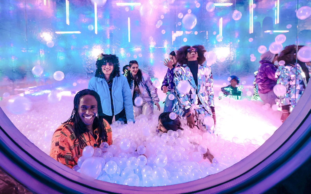 Group enjoying a vibrant ball pit experience at House of Hype.