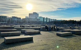 Berlin Holocaust Memorial with visitors during a self-guided city exploration game.