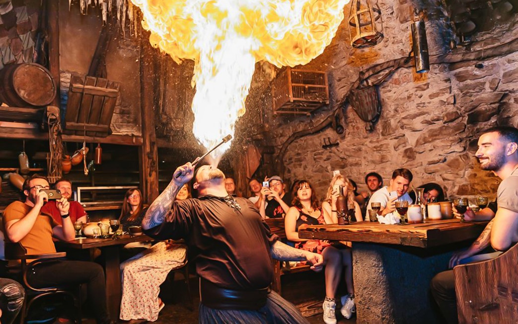 Fire performer entertaining guests at Medieval Dinner in Prague.