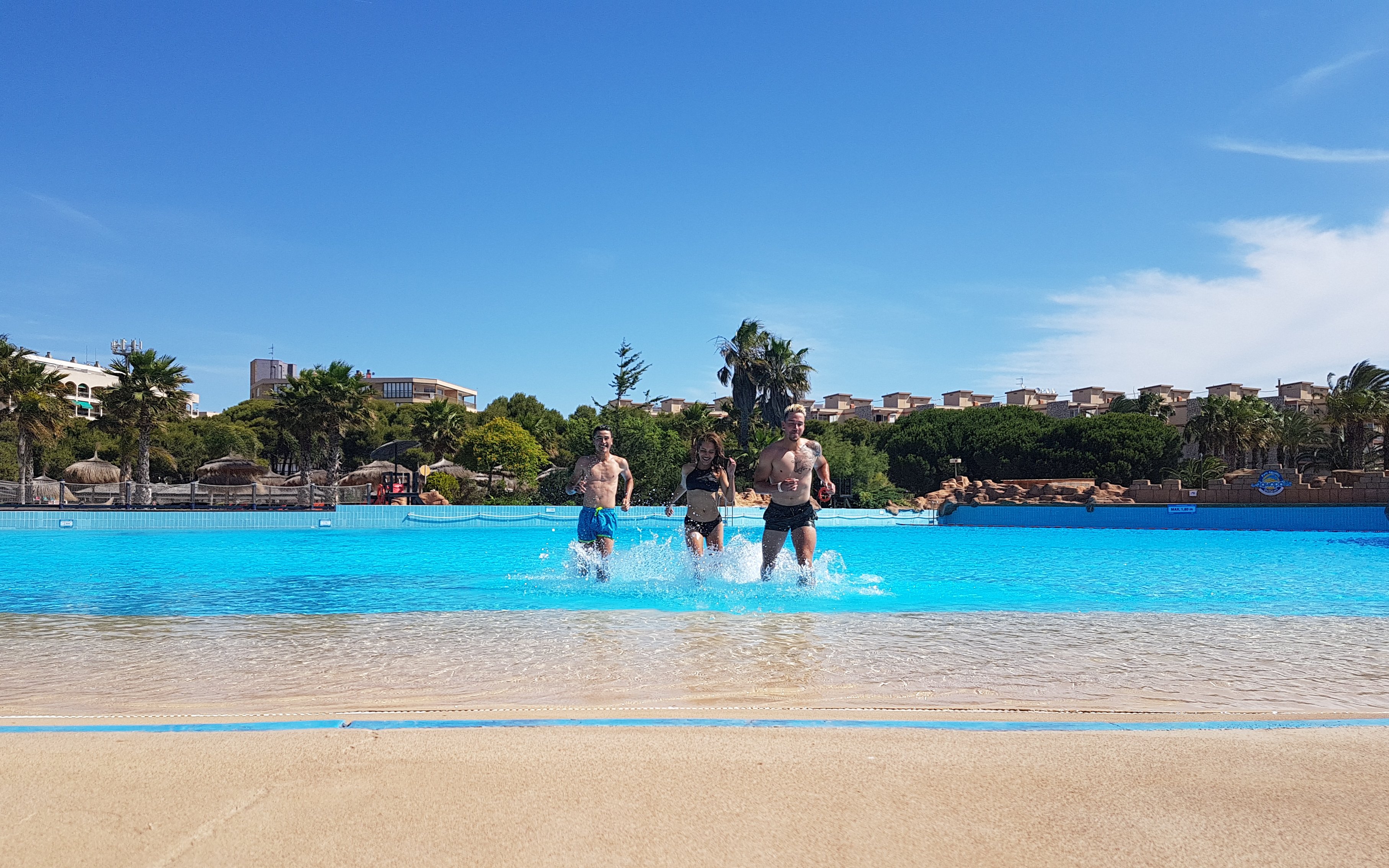 Visitors enjoying the wave pool at Aquopolis Costa Daurada, Tarragona.