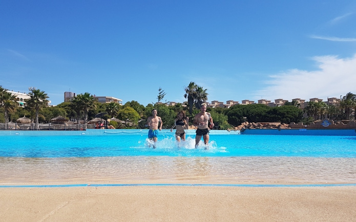Visitors enjoying the wave pool at Aquopolis Costa Daurada, Tarragona.