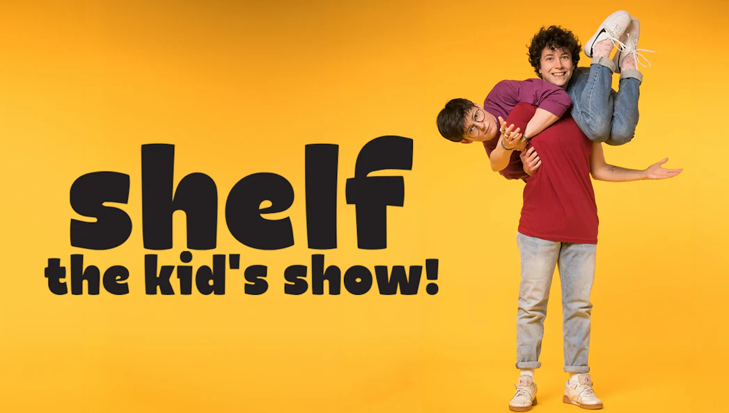 Two performers in playful pose for "Shelf: The Kids' Show" on yellow background.