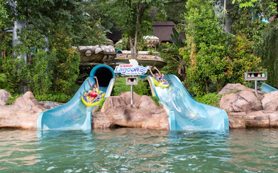 Visitors enjoying waterslides at Sunway Lagoon Theme Park, Malaysia.