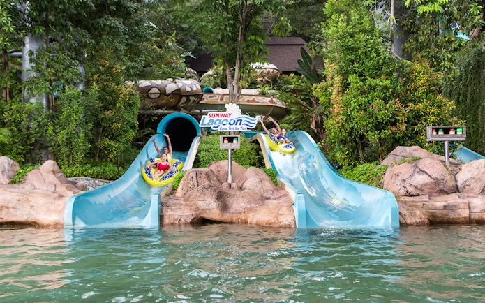 Visitors enjoying waterslides at Sunway Lagoon Theme Park, Malaysia.