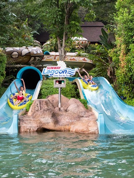Visitors enjoying waterslides at Sunway Lagoon Theme Park, Malaysia.